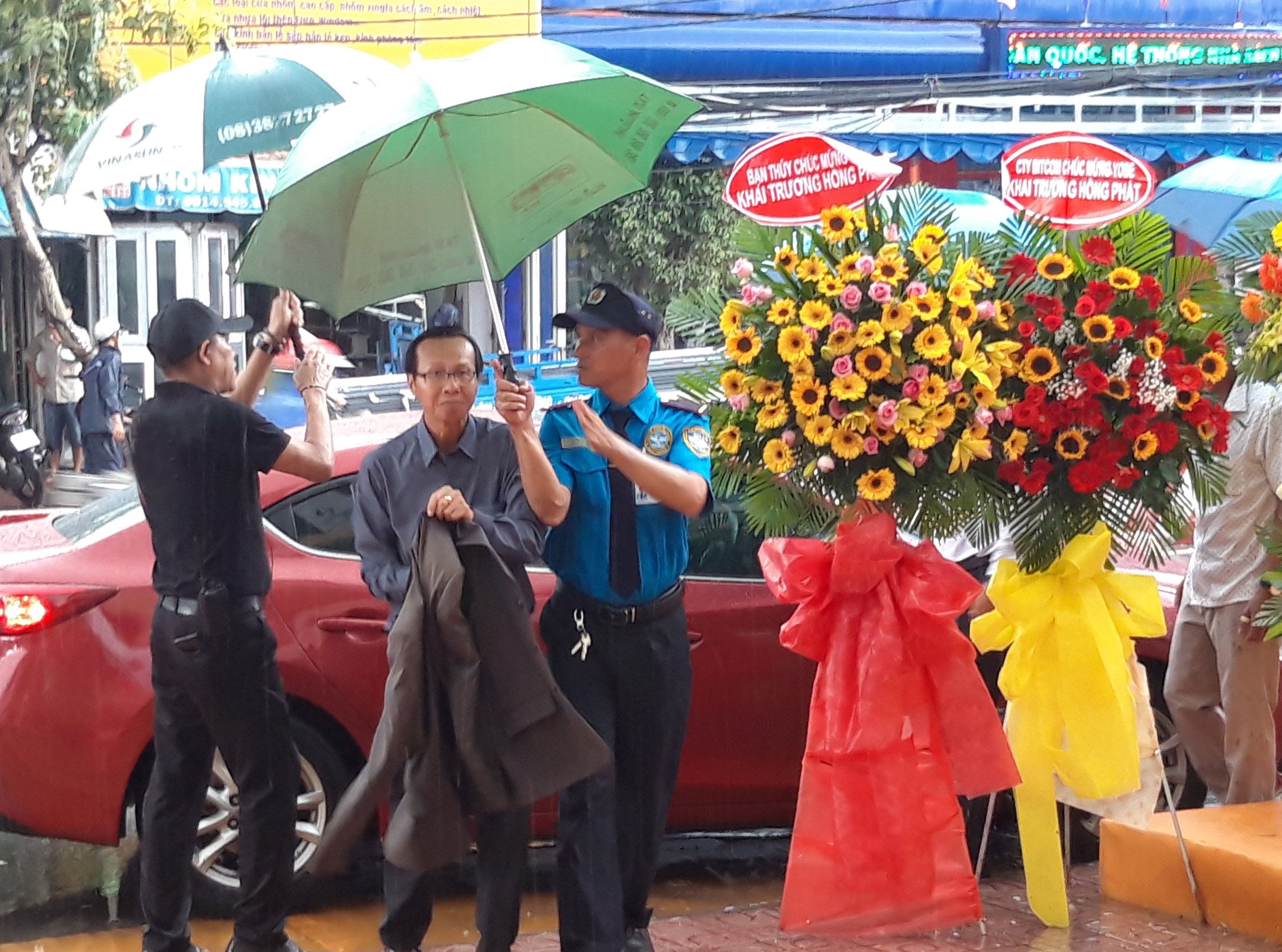 Bảo vệ Ku casino che dù cho khách tham dự khai trương